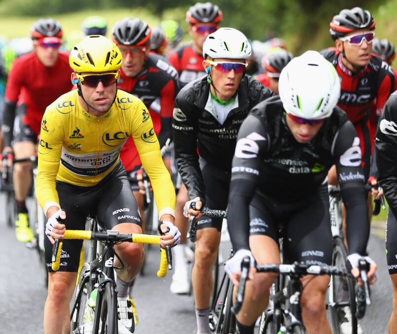 ON THE ROAD: Mark Renshaw rides in the peloton alongside his Dimension Data team-mate Mark Cavendish, who is wearing the yellow jersey. Photo: GETTY IMAGES 070416renshaw2