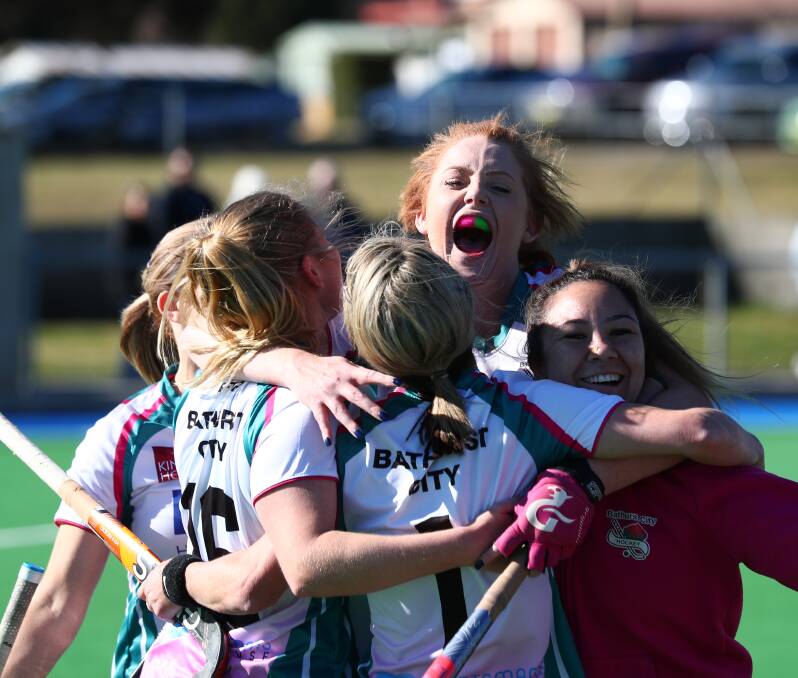 THE JUBILATION: Bathurst City defender Andrea Seymour embraces her team-mates after winning Saturday's grand final. Photo: PHIL BLATCH