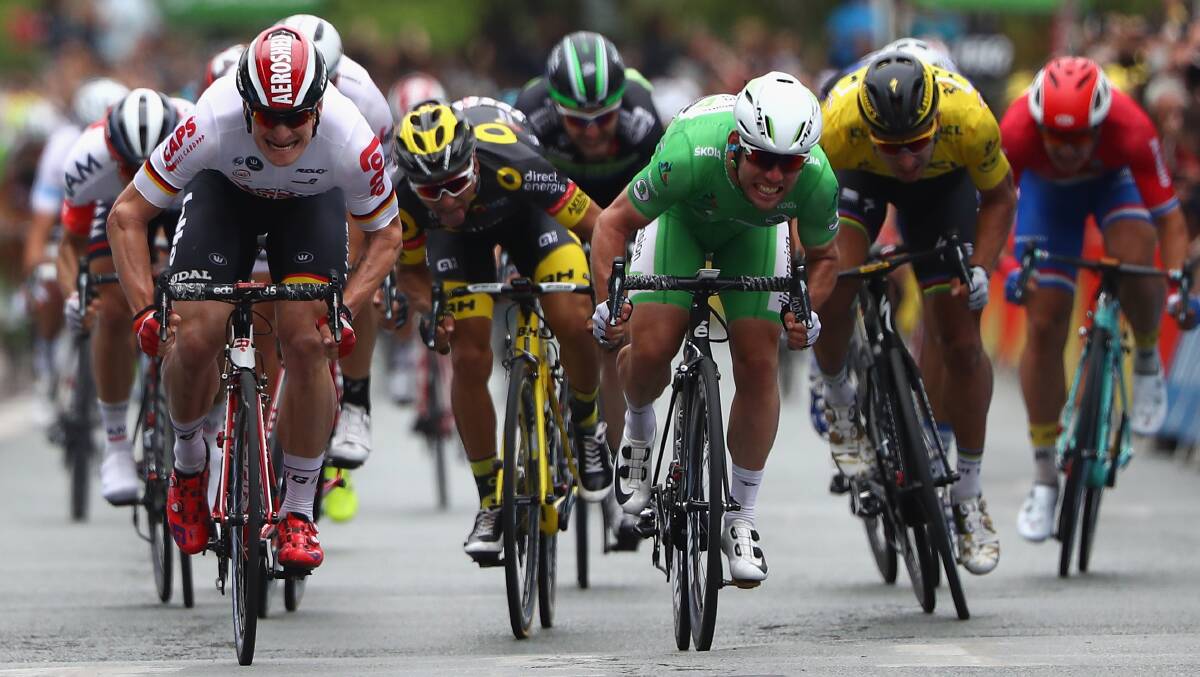EFFORT: Mark Cavendish (right) battles Andre Greipel (left) to the line in stage three of the Tour de France. Cavendish, following a good lead out from Bathurst's Mark Renshaw, won the stage. Photo: GETTY IMAGES 070516tourdefrance