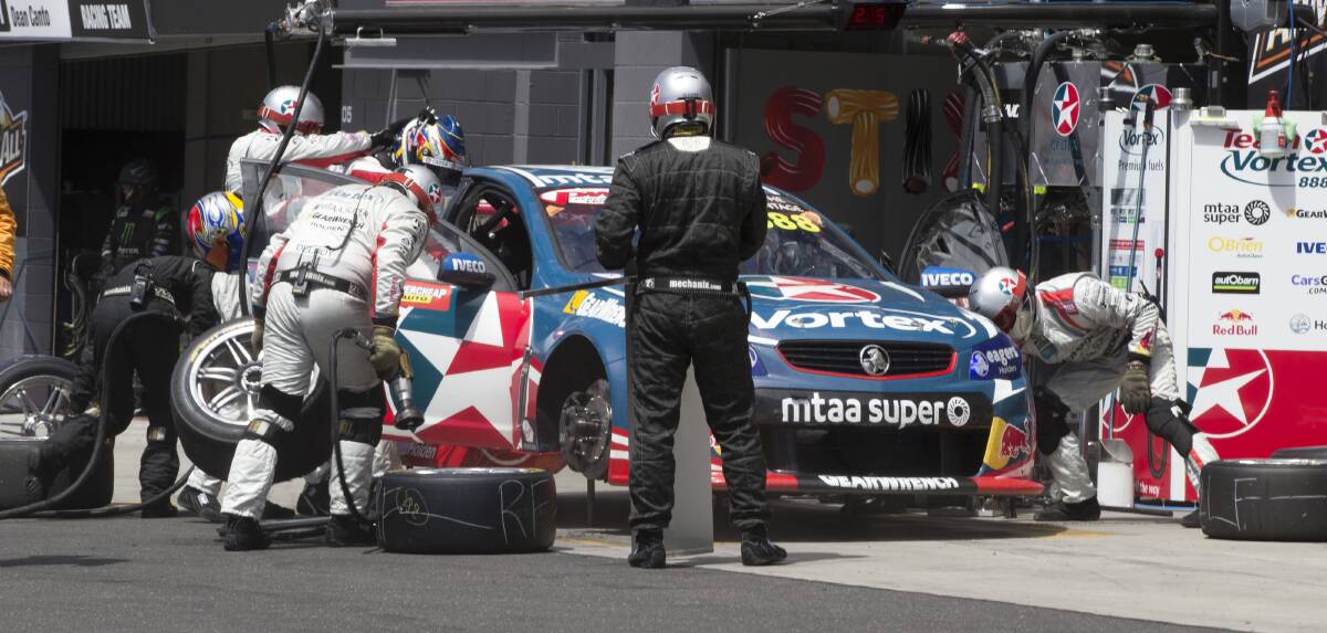 DISAPPOINTMENT: Craig Lowndes' pit crew work on fixing a gear lever issue during last year's Bathurst 1000.