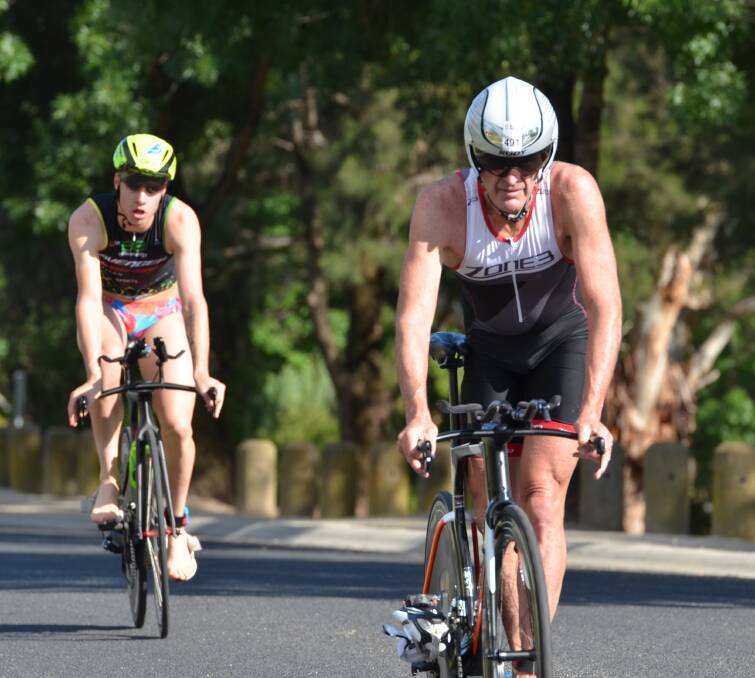 RIVALS: Mark Windsor leads Josh Stapley in the final metres of Sunday's cycle leg. He went on to win the long course event. Photo: ANYA WHITELAW