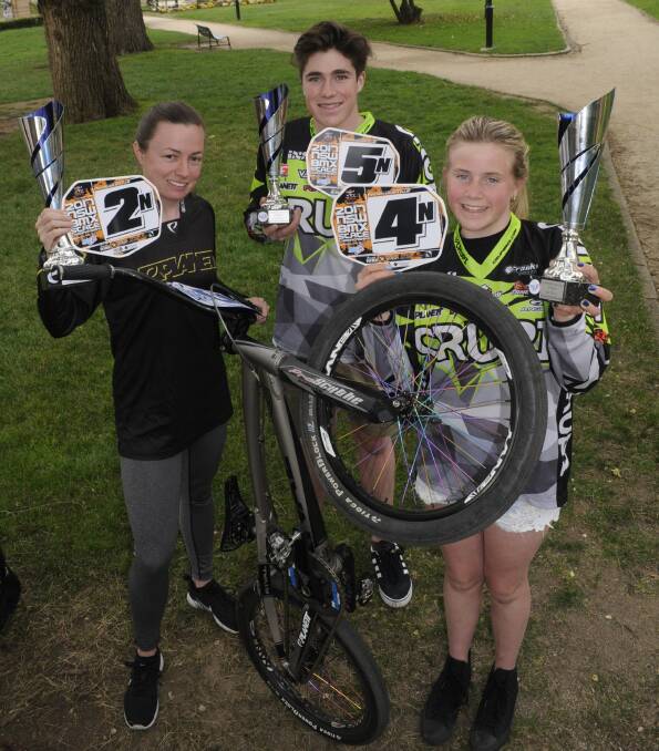 IMPRESSIVE: Bathurst BMX Club riders Hayley Wolfenden, Liam Westman and Chelsie Westman show off their state plates. Photo: CHRIS SEABROOK 100317cbmx1