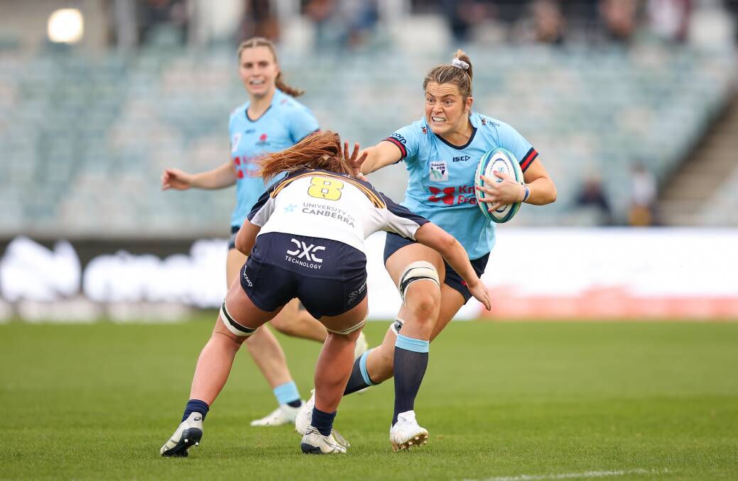 Grace Hamilton, another Central West product playing for the NSW Waratahs, shapes to fend off a Brumbies rival. Picture by Sitthixay Ditthavong