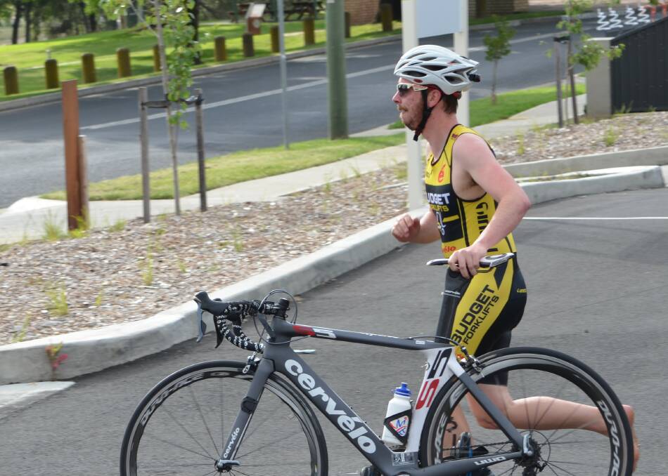 ON YOUR BIKE: Blair Windsor sets off on the cycle leg during one of last season's triathlons in Bathurst. Photo: ANYA WHITELAW 112215ytri2