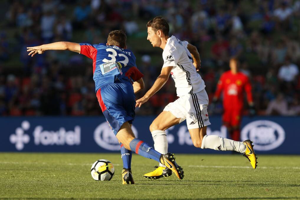 BACK ON TRACK: Nathan Burns (right) controls the ball during the A-League match between the Newcastle Jets and the Wellington Phoenix side he has recently reunited with. Photo: AAP