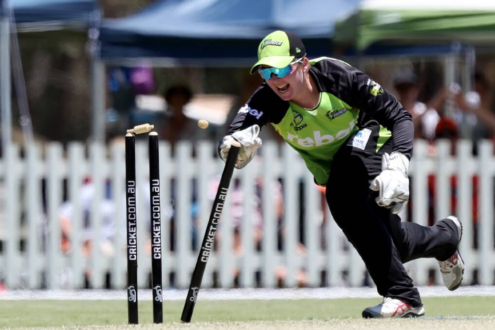 GOT HER: Rachel Priest breaks the stumps to complete the run-out. Photo: AAP