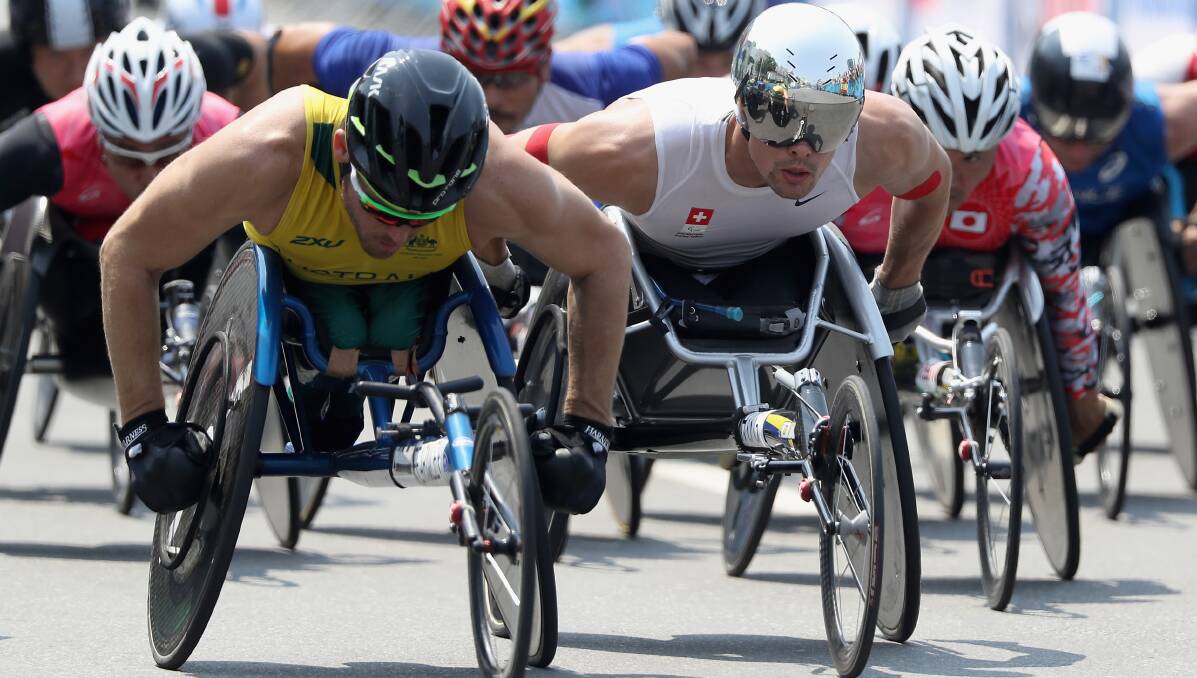 PUSHING HARD: Kurt Fearnley and eventual victor Marcel Hug (right) lead the pack in the opening stages of the marathon. Photo: GETTY IMAGES
