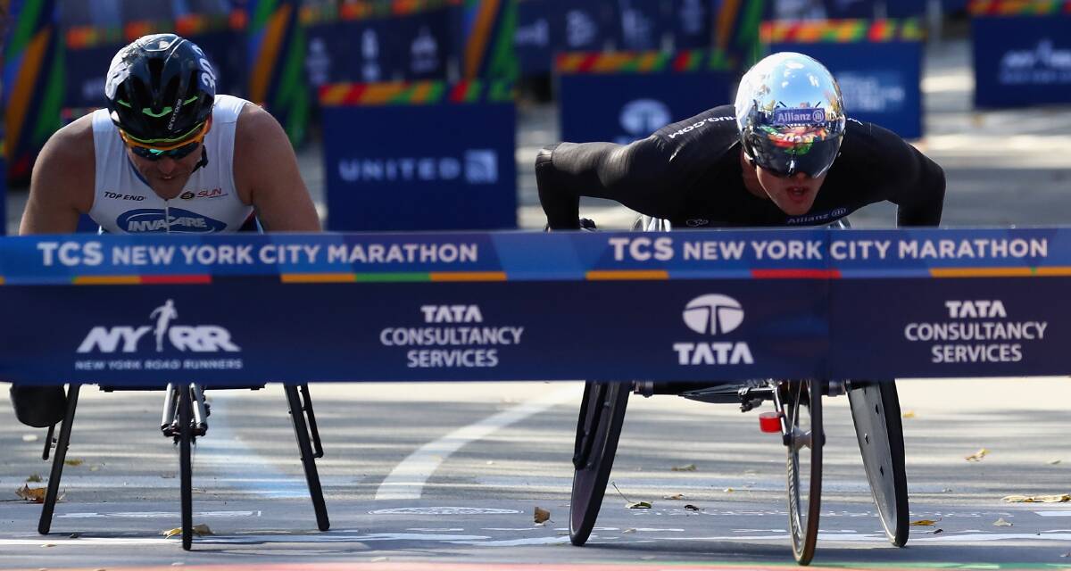 SO CLOSE: Kurt Fearnley (left) is beaten by mere inches by Marcel Hug after the pair sprinted to the line in Sunday's New York Marathon. Photo: GETTY IMAGES 110716fearnley