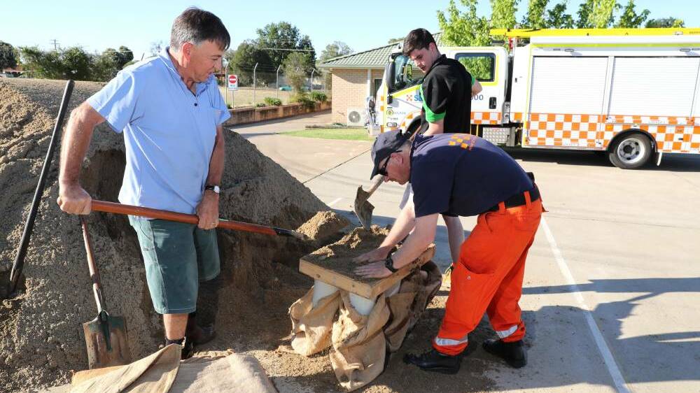Cliff Rose, David Tong and Toby Shaw sand-bagging at the Wagga SES centre on Fernleigh Road. Picture: Les Smith