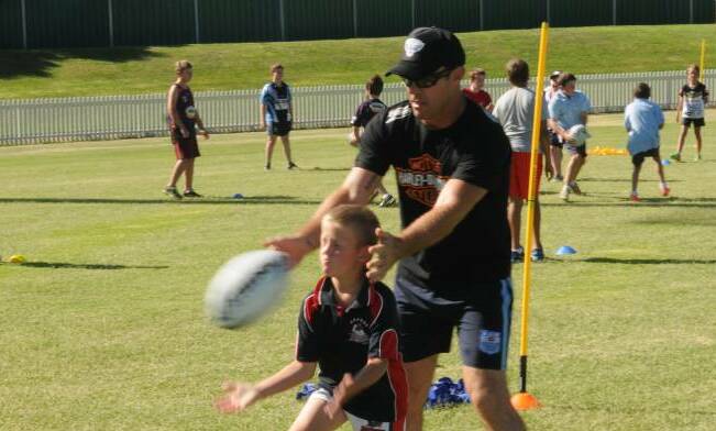 IN THE THICK OF IT: Brad Fittler at the last Hogs For The Homeless clinic at Wade Park. Photo: MARK LOGAN