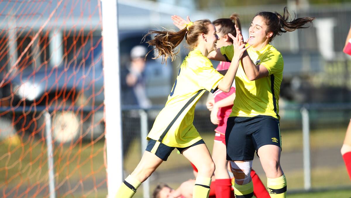 BACK IN TIER TWO: Western's Cushla Rue and Jess Salomoni celebrate one of their side's 16 goals against the struggling Eagles. Photo: PHIL BLATCH