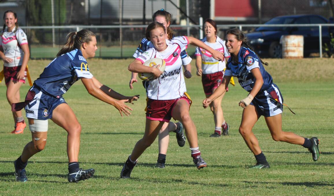 KICKING THINGS OFF: Hawks pair Bec Ford (left) and Erin Naden (right) attempt to tag Bears gun Sophie Stammers during the Western Challenge. Photo: NICK McGRATH