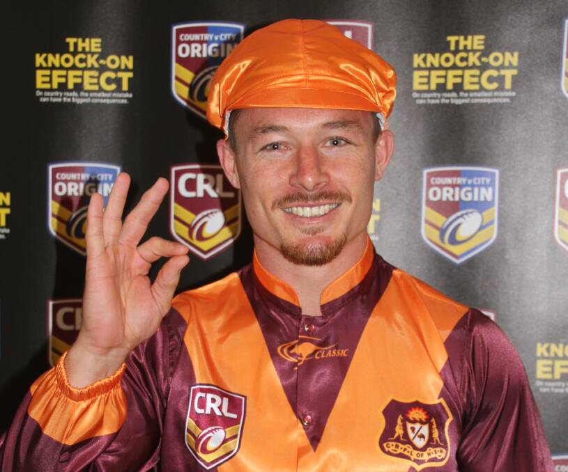 VERY NICE: Country hooker Damien Cook models the special maroon and gold coloured country silks to be worn on Saturday. 