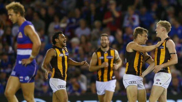 Cyril Rioli and Sam Mitchell celebrate the win with James Sicily who kicked the winning goal. Photo: Getty Images