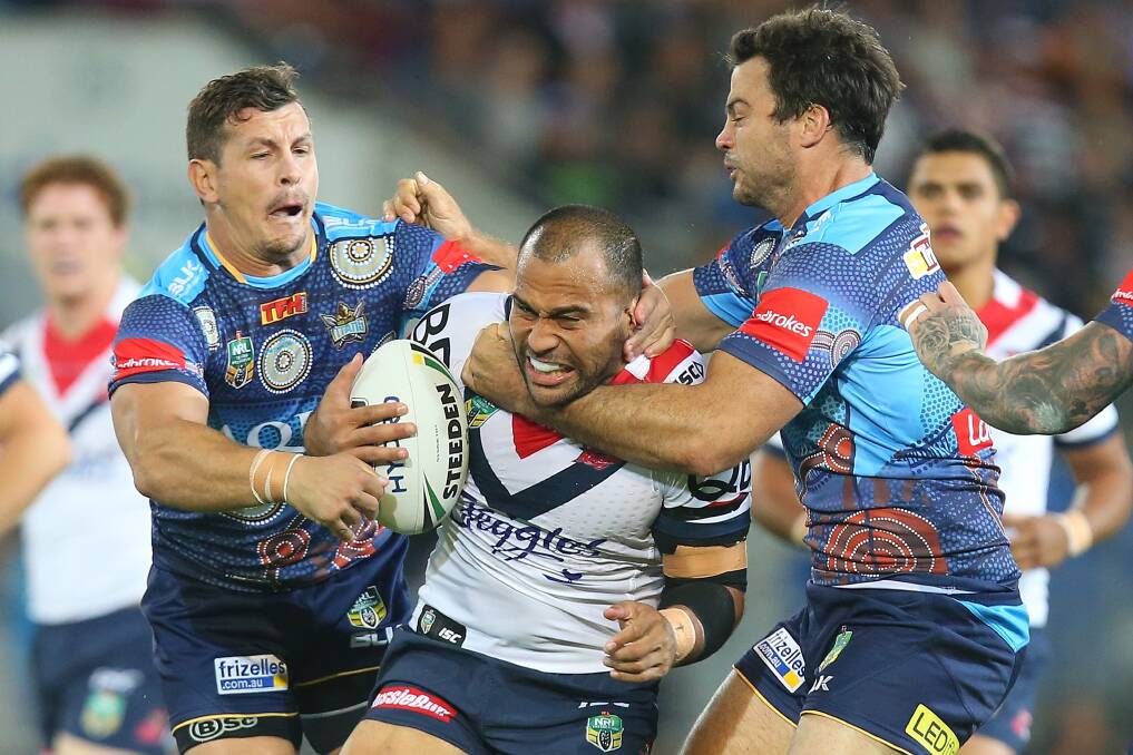 HARDCORE: Sam Moa of the Roosters is tackled during the round 10NRL match between the Gold Coast Titans and the Sydney Roosters at Cbus Super Stadium. (Photo by Chris Hyde/Getty Images)