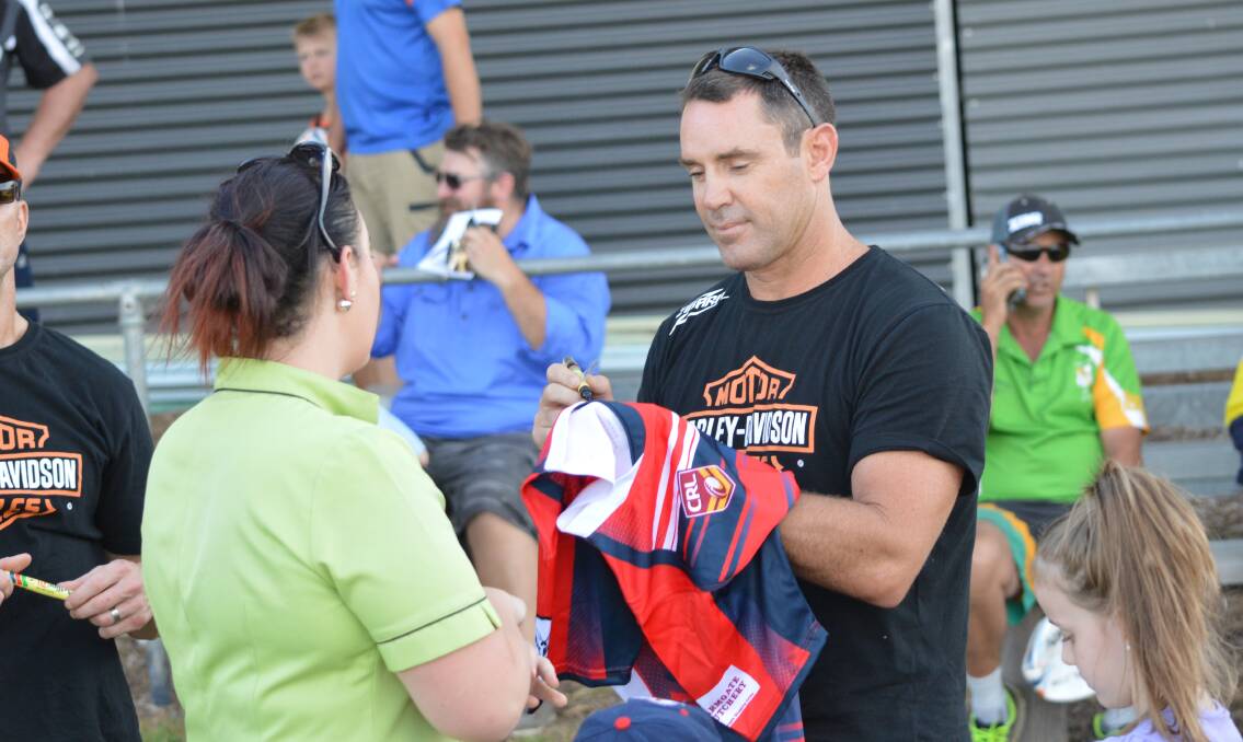SUPERSTAR: Brad Fittler signs and Orange Barbarians jersey on Friday afternoon, when his Hogs for the Homeless tour rolled into town. Photo: MATT FINDLAY