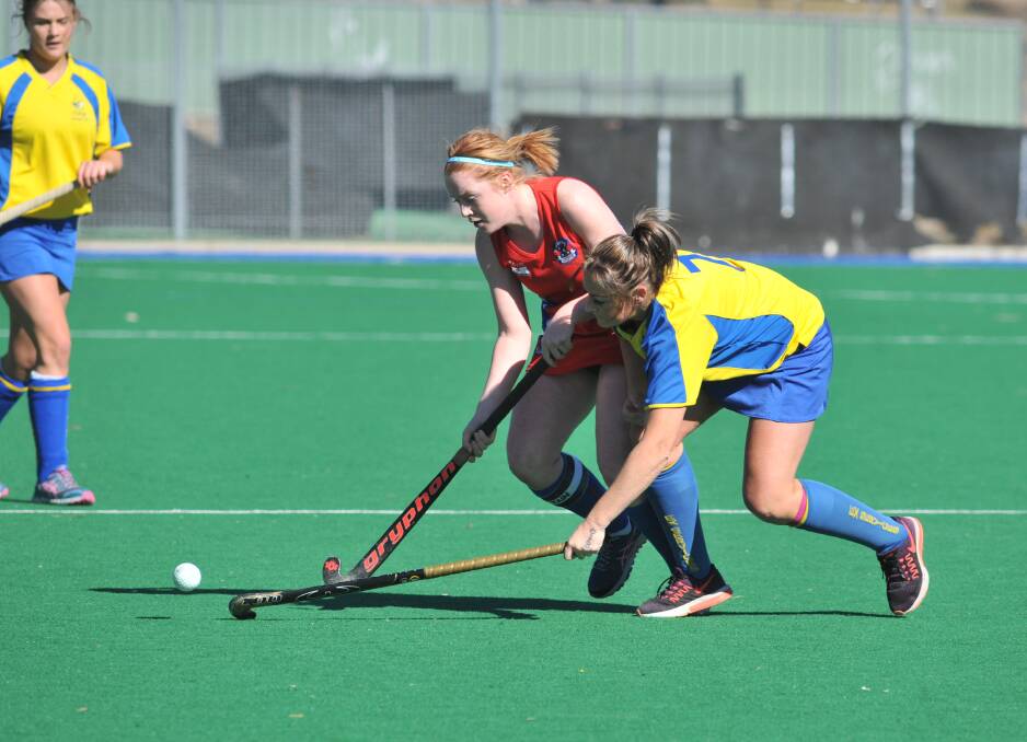 HARD-FOUGHT: Confederates skipper Annabelle Tierney and Ex-Services ace Leanne Kennewell fight for possession in Saturday's epic derby encounter. Photo: JUDE KEOGH