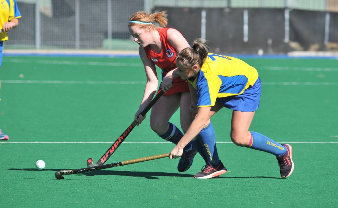 INSPIRATIONAL LEADER: Tierney battles for possession with Ex-Services gun Leanne Kennewell during last weekend's women's Premier League Hockey derby. Photo: JUDE KEOGH