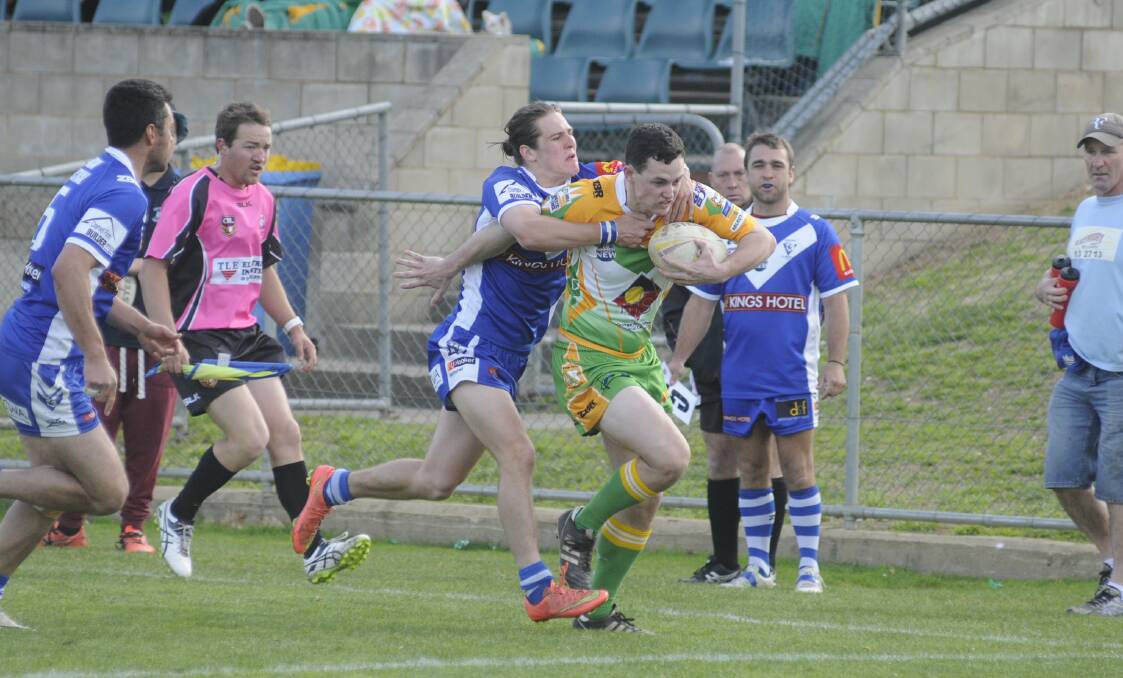 TACKLE BUST: CYMS wingers Todd Murphy tries to brush off his St Pat's counterpart in the green and golds' loss on Sunday. Photo: CHRIS SEABROOK