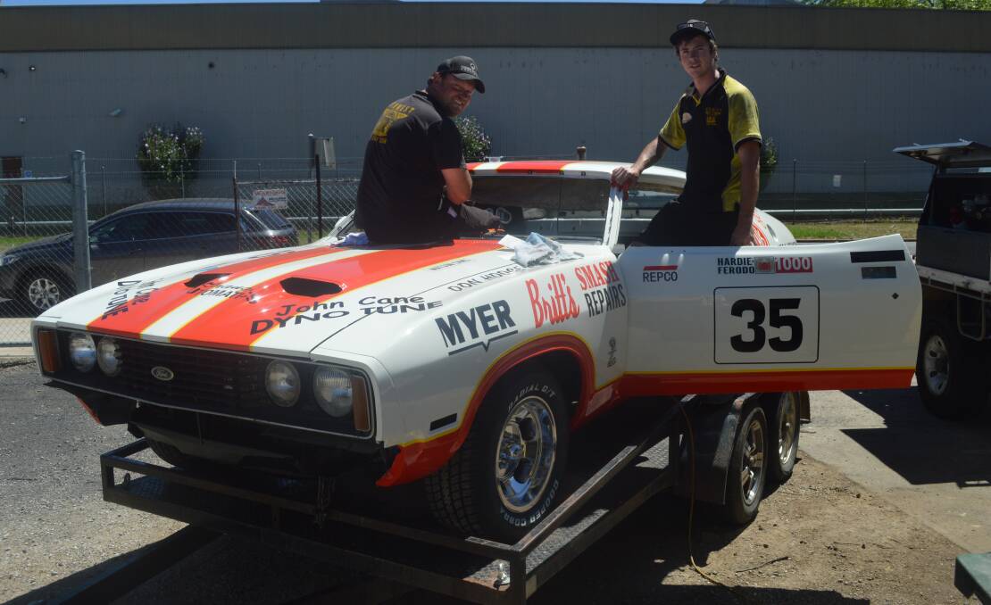 BLAST FROM THE PAST: Midwest Mufflers and Mechanical's Darrin Davis and Jay Miller fit the Swalding brothers' replica's windscreen on Thursday afternoon, in the lead-up to this weekend's Gnoo Blas Classic. Photo: MATT FINDLAY