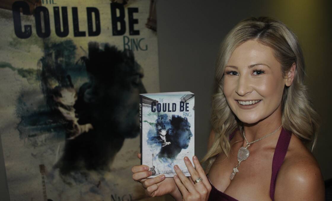 WRITE STUFF: Bathurst author Alexandria Nagy with her book The Could Be Ring. Photo: CHRIS SEABROOK  062417cbook1a