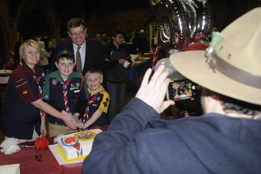SNAPSHOT: Calare MP Andrew Gee helps scouts Sarah Hardie, Bailey Fraser and Lochie McGuire cut the 3rd Bathurst group's 85th birthday cake.