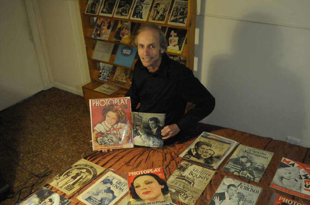 GOLDEN AGE: Bathurst film buff Noel Cowan with a selection of his vintage movie programs and fan magazines. Photo: CHRIS SEABROOK