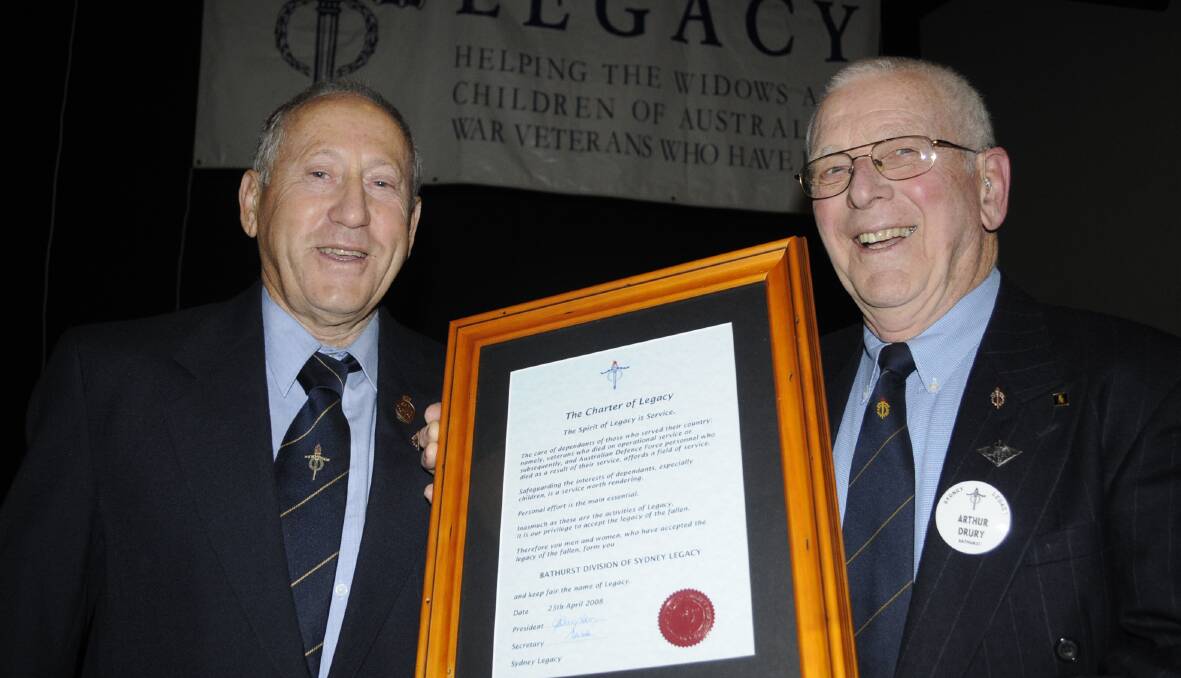 CONGRATULATIONS: Outgoing Bathurst Legacy president Geoff Woolfe hands over the Charter to incoming president Arthur Drury. 062516clegacy