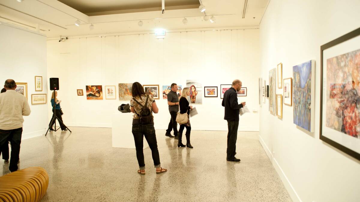 WALL TO WALL: Art enthusiasts look at the works during the Bathurst Art Fair 2013. The event will celebrate its 10th anniversary when it opens in late September. Photo: CLARE LEWIS