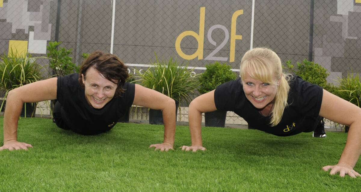 WORKOUT: Renelle Fitzgerald and Bev Glen get in some last-minute training ahead of their 5000 push-up challenge over the next month. Photo: CHRIS SEABROOK