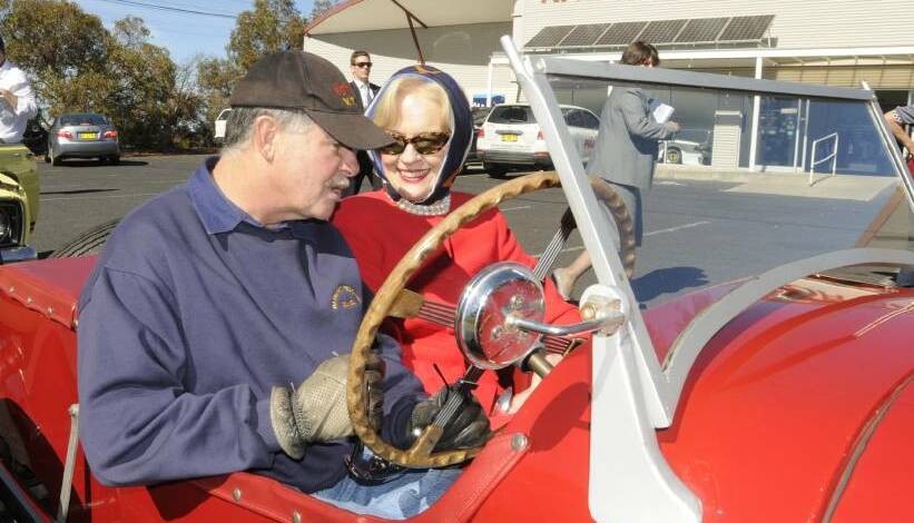 DRIVER'S WHEEL: Jailed Bathurst man Norm Rutherford pictured with former Governor General Quentin Bryce at Mount Panorama in 2013.