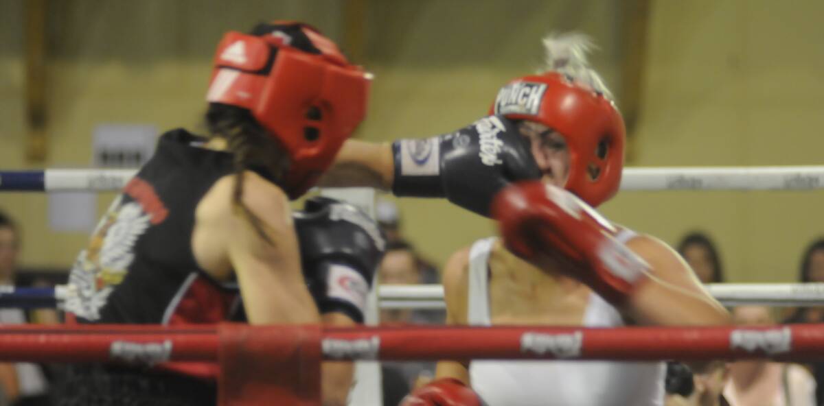 SNAPSHOT: Enja Prest lands a blow on Bathurst's Sam Mulley during Saturday's fight night at Bathurst Showground. Photo: CHRIS SEABROOK
