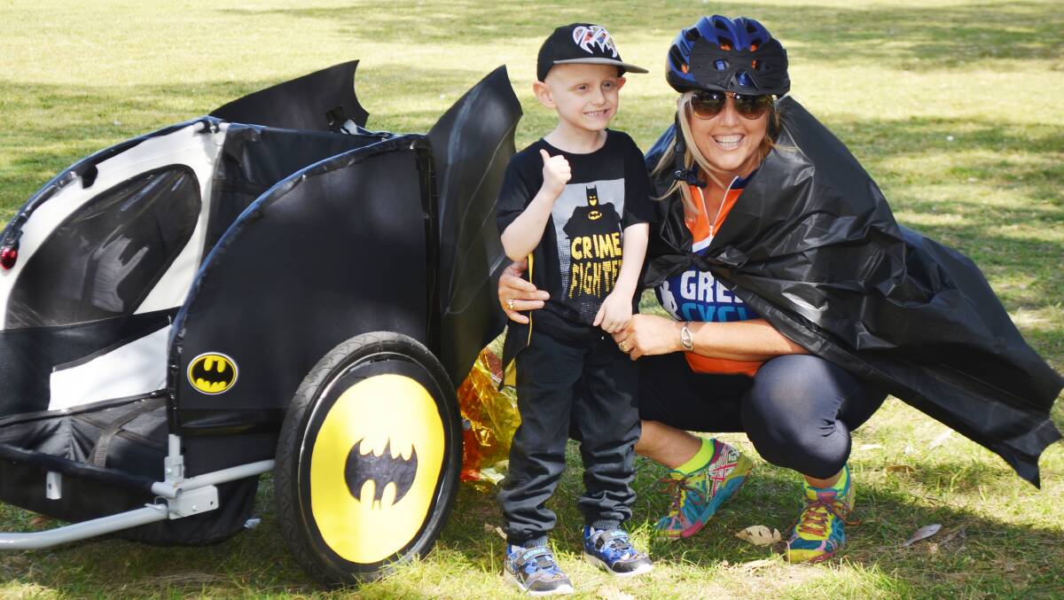 THUMBS UP: Bathurst boy Brody Miller with Children’s Medical Research Institute volunteer Kim Guisa and the Batman sidecar made for him by volunteers. Photo: SUPPLIED