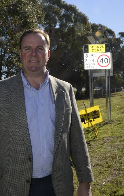 SAFETY FOR STUDENTS: All Saints' head of college Stephen O'Connor standing out the front of the newly installed school zone. Photo: PHILL MURRAY 062916plights2