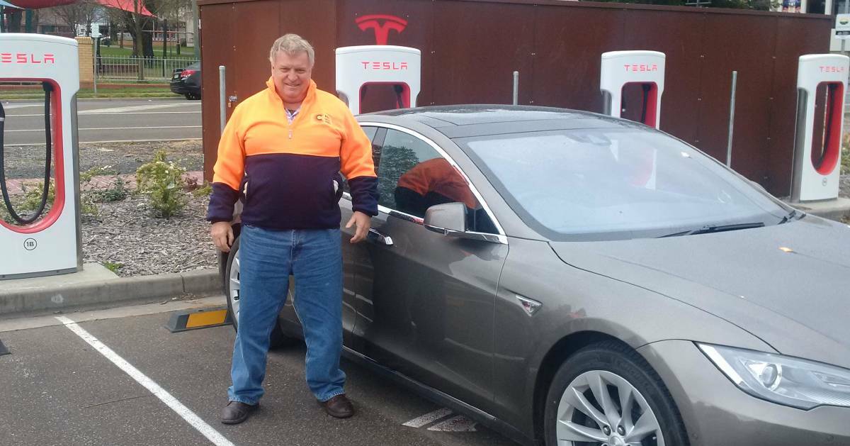 FILL 'ER UP: Sun Share team member Darryl Leahey with Tesla D90 at Goulburn Supercharge station en route to Melbourne. Photo: SUPPLIED