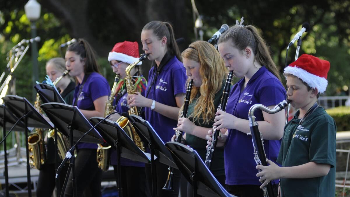 SNAPSHOT: The Mitchell Conservatorium's Saxinets ensemble entertains the huge turnout at Sunday's Carols by Candlelight. Photo: CHRIS SEABROOK