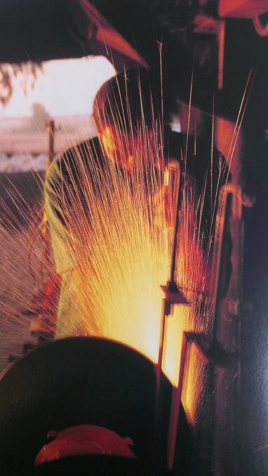 SPARKS FLY: A professional shearer is captured in this spectacular photo grinding a wide comb.