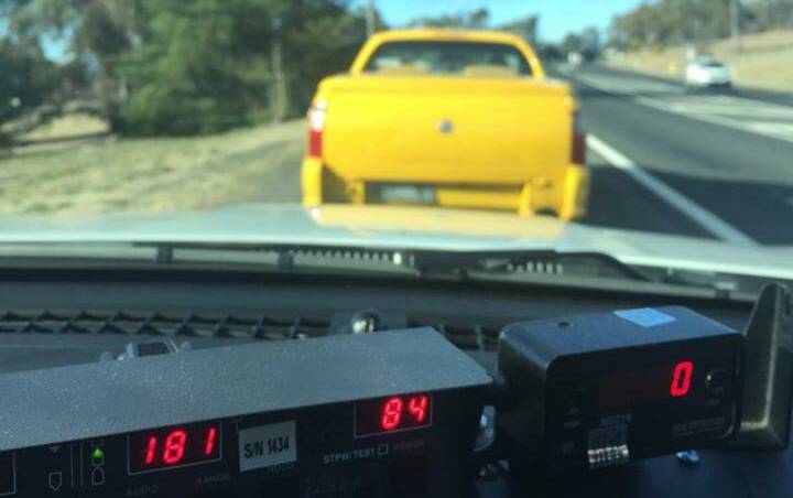 The yellow Holden Commodore pulled over beside the Mid Western Highway. Photo: Traffic and Highway Patrol Command - NSW Police Force