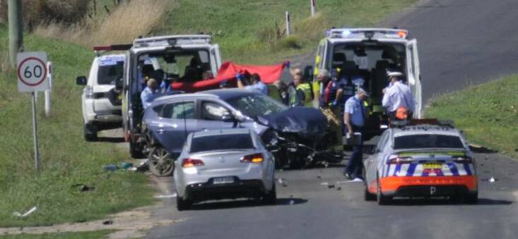 CRASH SCENE: Police vehicles on the scene of the fatal crash on the Vale Road last year.
