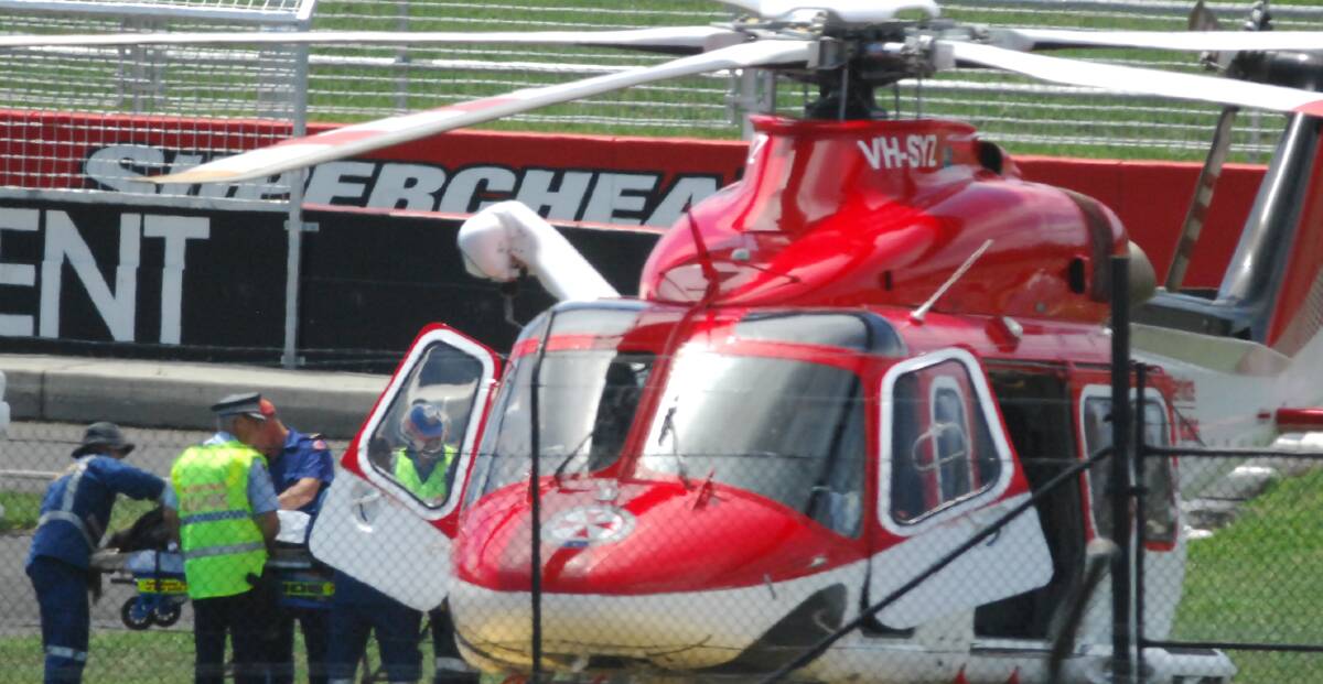 FATAL CRASH: Emergency services and a rescue helicopter on the scene of a fatal collision between a car and motorbike on Mount Panorama in January 2015.