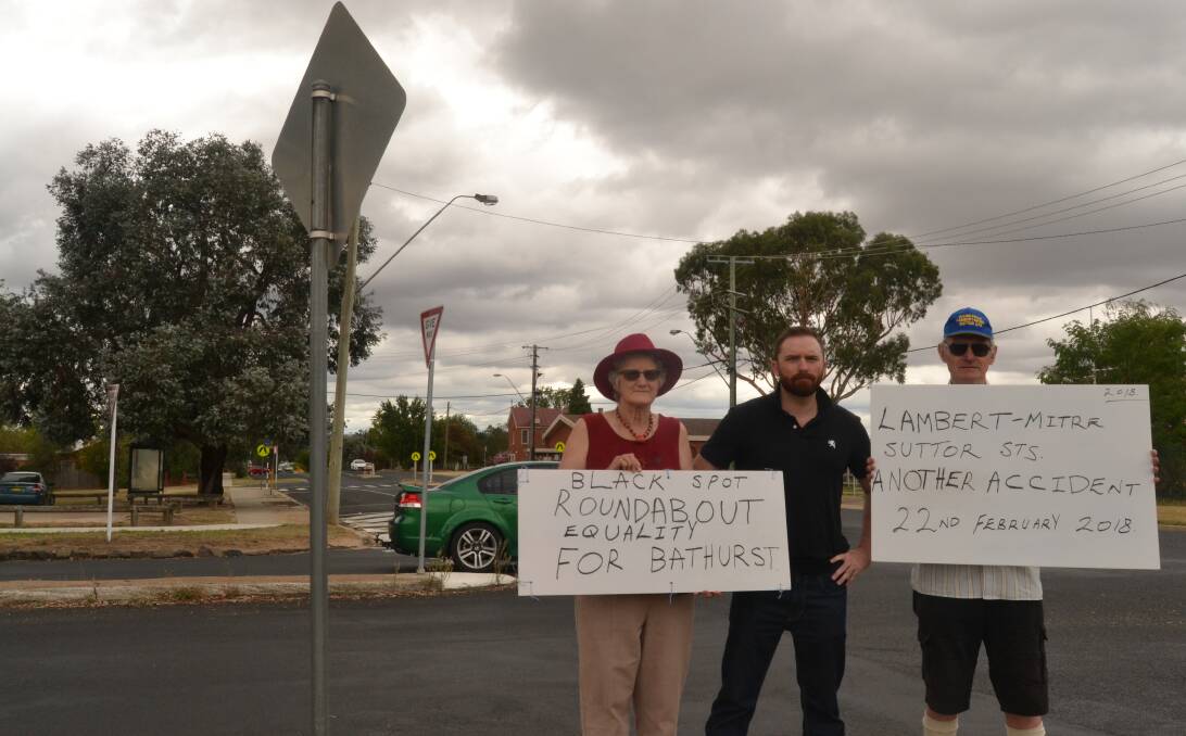 ROUND IN CIRCLES: Councillor Alex Christian (centre) with roundabout campaigners Dianne and Kent McNab at the West Bathurst intersection.