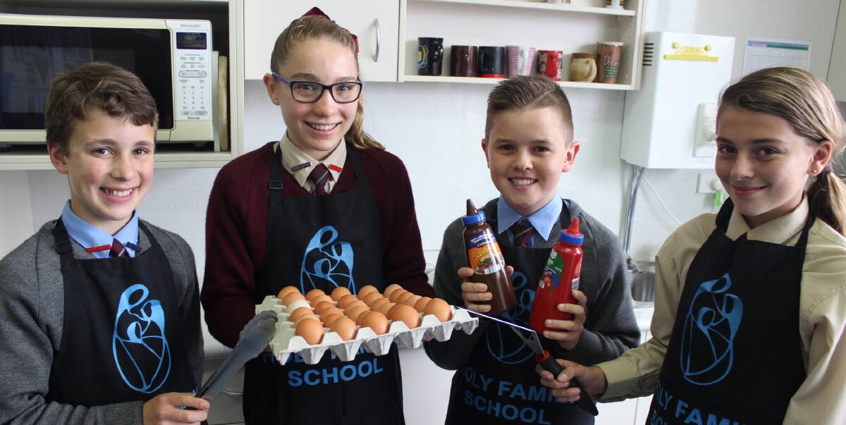 COME AND GET IT: Holy Family School captains Tyler Sharwood, Tess Wilson, Will Brown and Kelsey Webb cooking up a feast for the annual Father's Day Big Brekkie. 090116holy