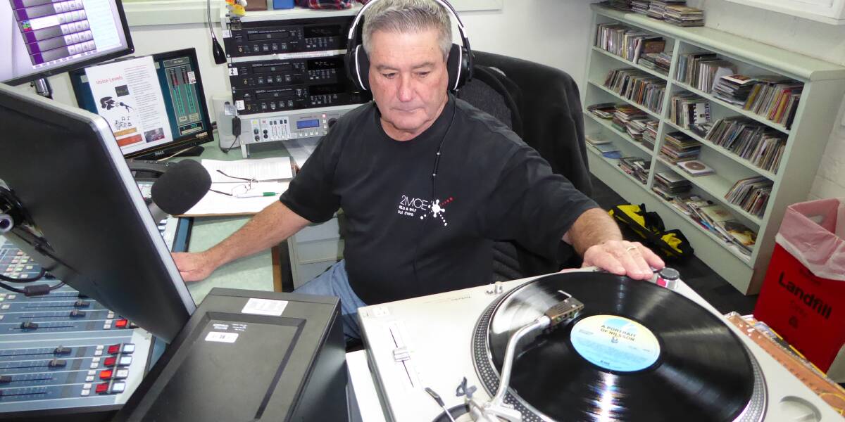 MUSIC MAN: Back To Vinyl presenter Ron Gibson prepares to spin in another vinyl track inside the 2MCE studios at Charles Sturt University.