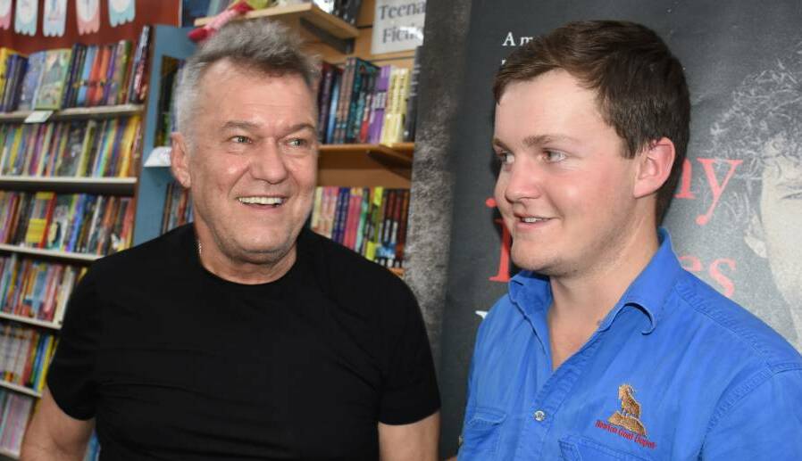 HSC: "Working Class Man" Jimmy Barnes with "Top of the Class Man" Darragh Newton during Barnes' recent book signing at Books Plus Bathurst. Darragh had driven from Bourke to meet his hero. Photo: NADINE MORTON