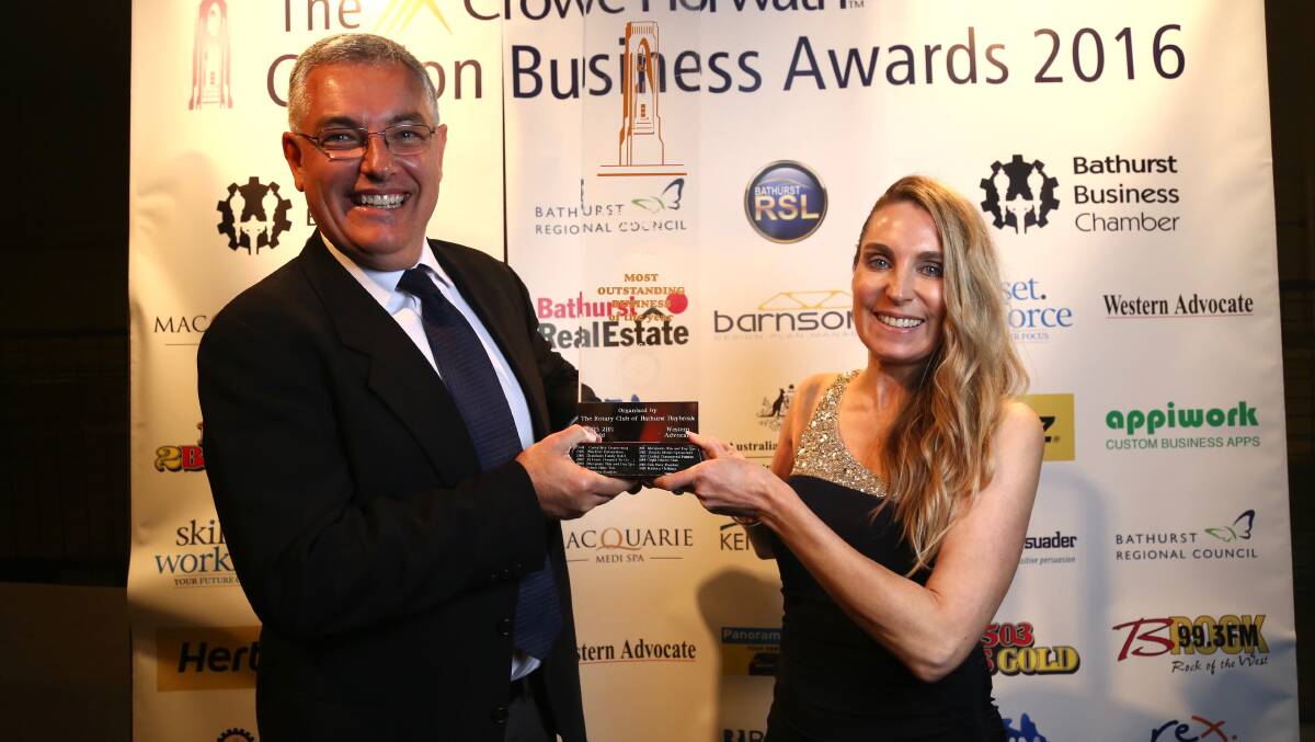 BEST IN BUSINESS: Dean Porter from awards sponsors Crowe Horwath congratulates Carillon Award winner Melissa Gregory from Bobbies Clothing Bathurst on Friday night. Photo: PHIL BLATCH