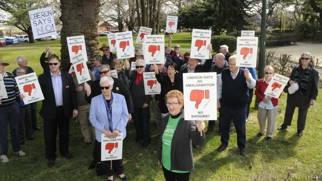 WINNERS ARE GRINNERS: Oberon mayor Kathy Sajowitz and anti-amalgamation organiser Marj Armstrong with supporters during a rally in Bathurst last year.