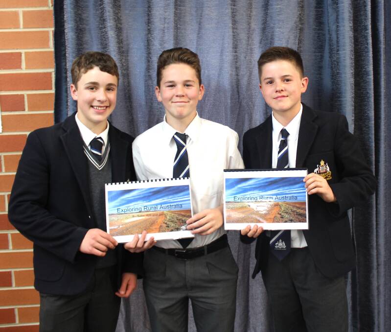 BOOKS FOR FIJI: Tyler Sharwood, James Patterson and Will Brown with the books that are being sent to Fiji.
