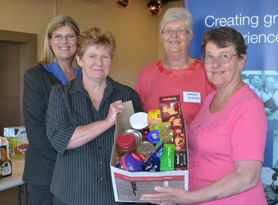 HELPING HAND: Janelle Davis and Margaret Duncombe from Spotlight with Bathurst City Community Club volunteers Margaret Moorhead and Helen Horne.
