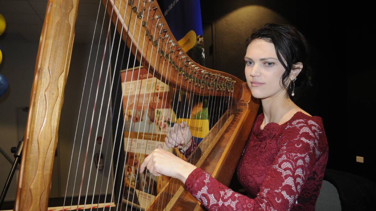 MUSIC: Bethany Carter provided background music on her Lever Harp at the Rotary Club of Bathurst Emergency Service Awards night. Photo:CHRIS SEABROOK 072217crotary