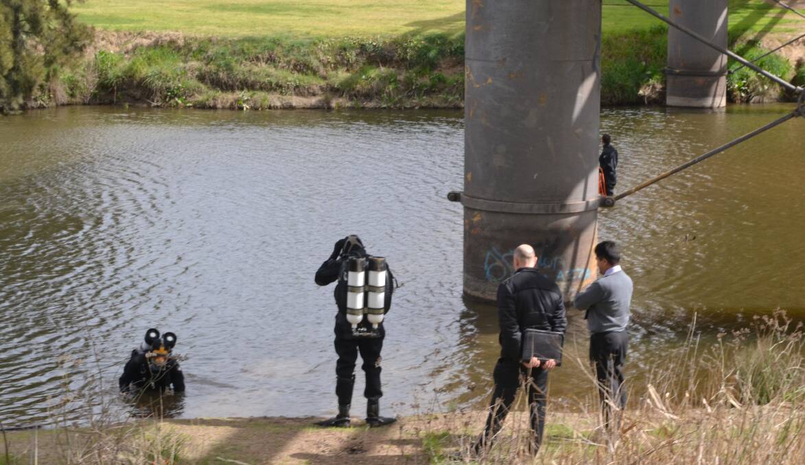 INVESTIGATION: Specialist divers joined homicide police and Chifley detectives searching for evidence in Reg Mullaly's murder on the banks of the Macquarie River last year.